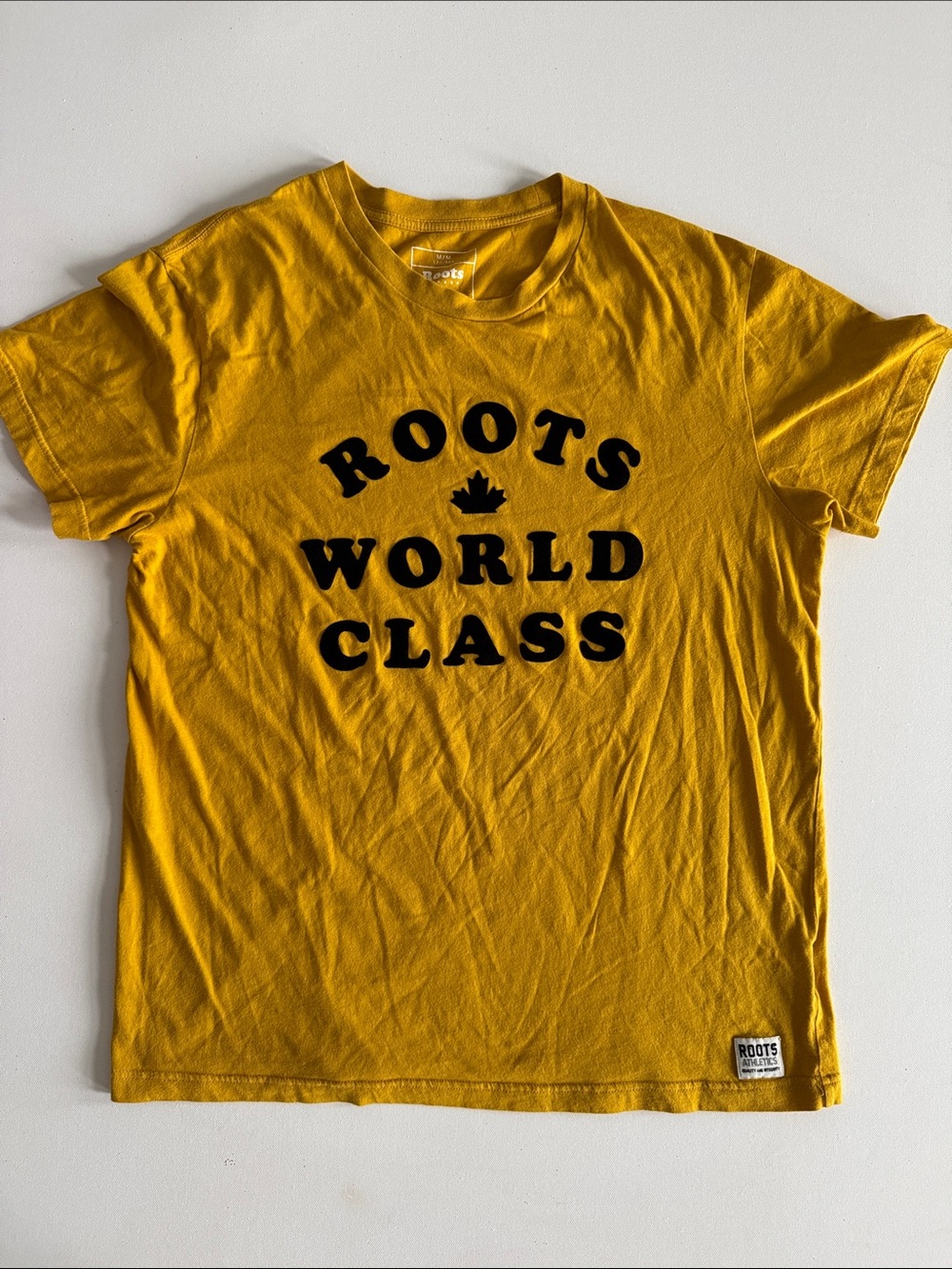 Roots Yellow T‑Shirt with Black 'World Class' Logo